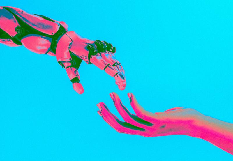 A robotic hand reaching for a human hand