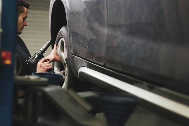 Mechanic installing a car wheel