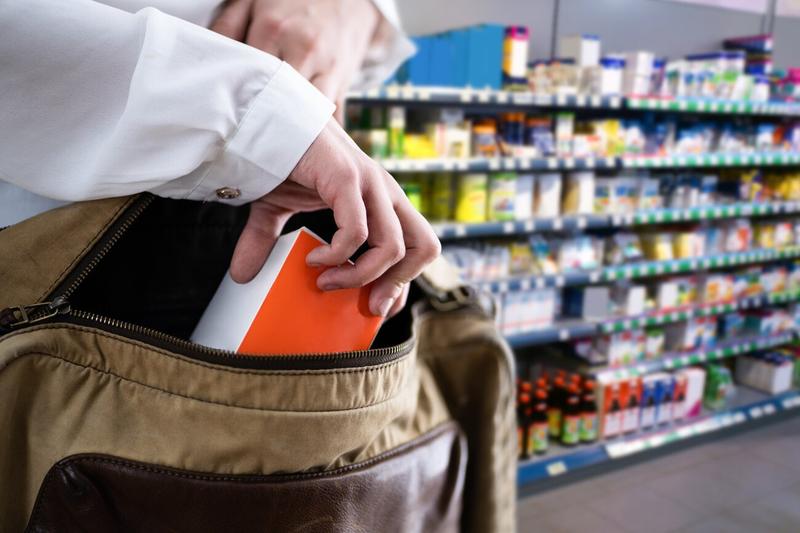 Person attempting to steal an item in a supermarket