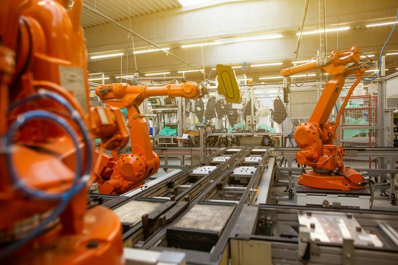 Image of a factory with mechanical arms